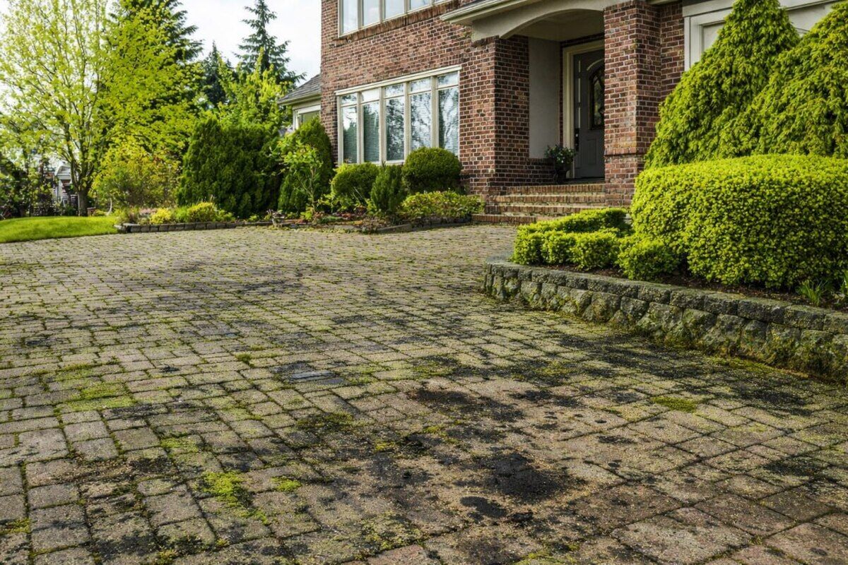 Cracked faded driveway before sealing